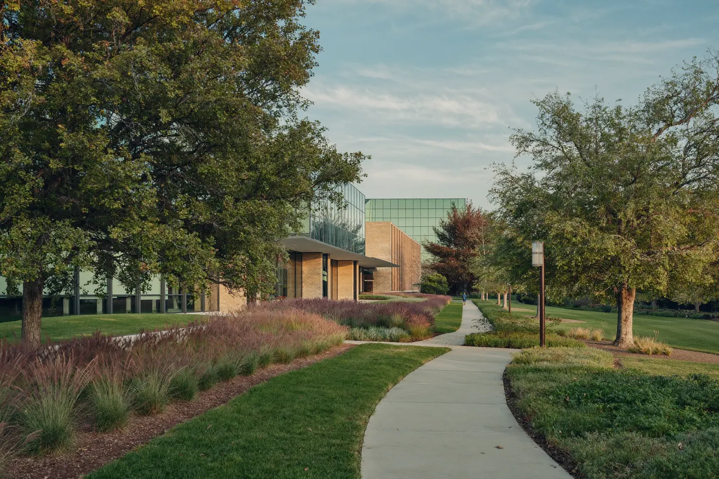 A landscaped walking path through a low rise office campus in Greenwood Village