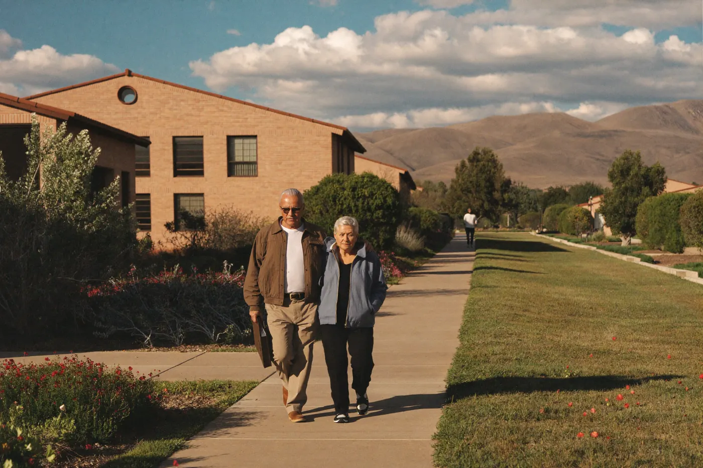 An older couple walking a landscaped path through a Colorado independent living community