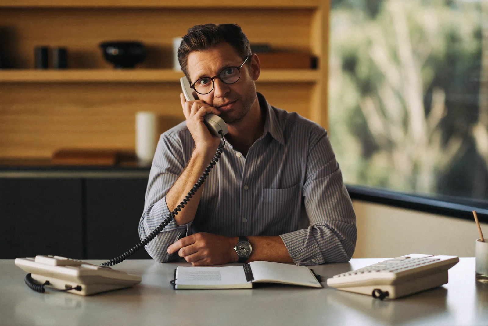 Advisor taking a calm early planning call at a tidy desk