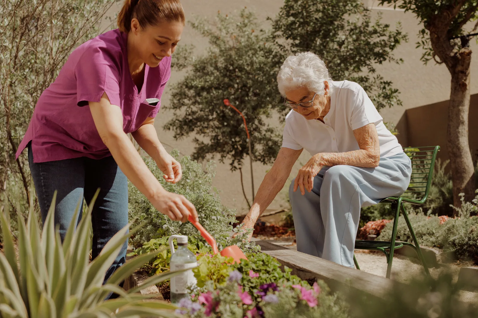 Resident tending a raised garden bed in a secured courtyard