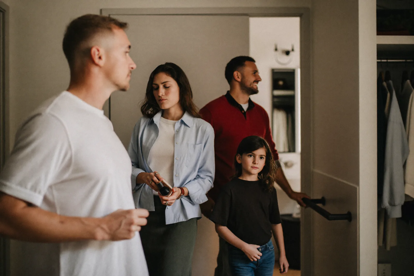 Family checking a bathroom grab bar during an apartment tour