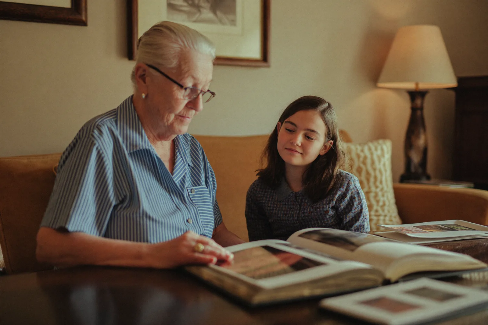 Elderly woman and her daughter looking through a photo album